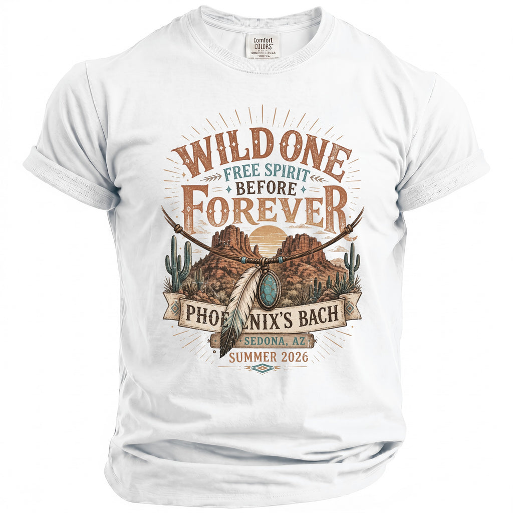 White t-shirt with graphic art featuring desert landscape, text "Wild One Free Spirit Before Forever Phoenix's Bach Sedona, AZ Summer 2026".