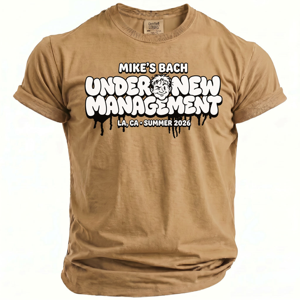 Tan t-shirt with text "MIKE'S BACH UNDER NEW MANAGEMENT LA, CA SUMMER 2026"