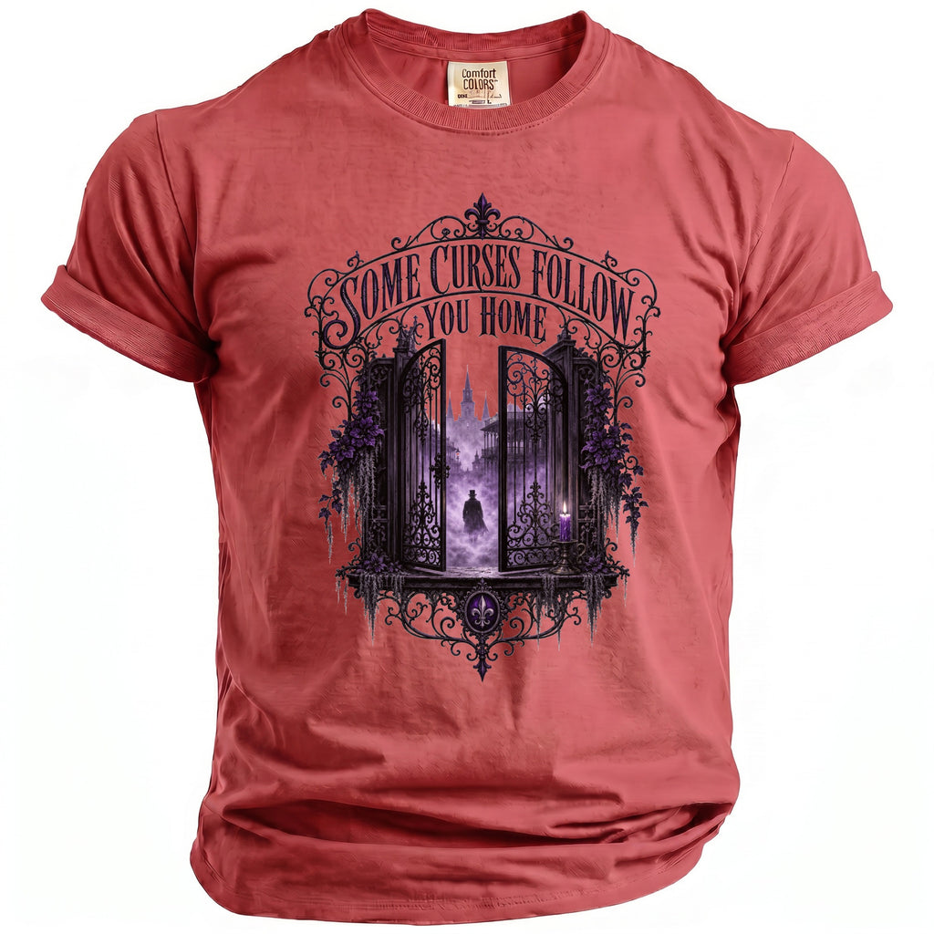 Red t-shirt with gothic gate, cloaked figure, and "SOME CURSES FOLLOW YOU HOME".