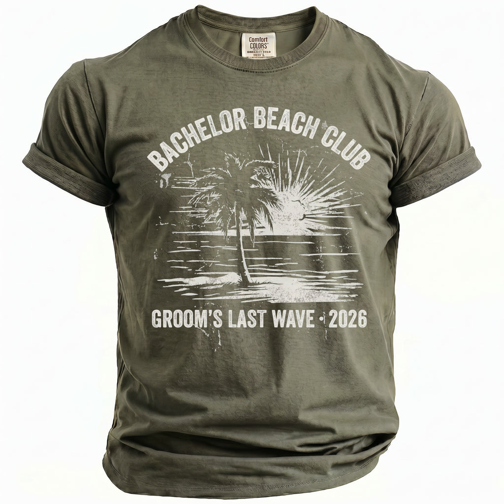 Olive green t-shirt with "BACHELOR BEACH CLUB" and "GROOM'S LAST WAVE 2026" text.