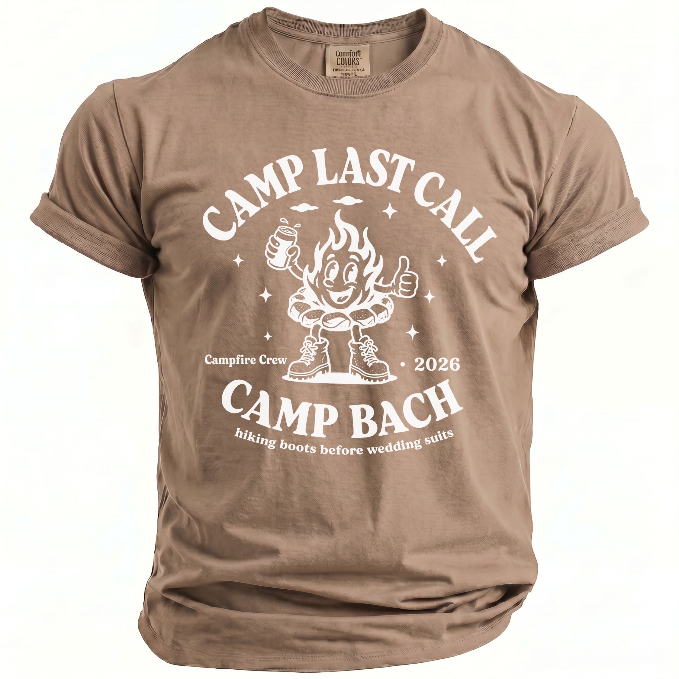 A tan crewneck t-shirt featuring white retro camping text and a cartoon campfire graphic.