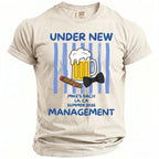 Light beige t-shirt with "UNDER NEW MANAGEMENT" and beer, cigar, and bow tie graphics.