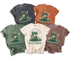 T-shirts with graphic of smoking dragon playing golf, text "Bachelor Golf Weekend".