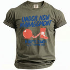 Khaki t-shirt with "Under New Management Mike's Bach" graphic.