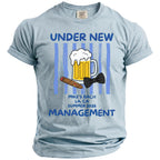 Light blue t-shirt with "Under New Management" and graphic of beer, cigar, bow tie.