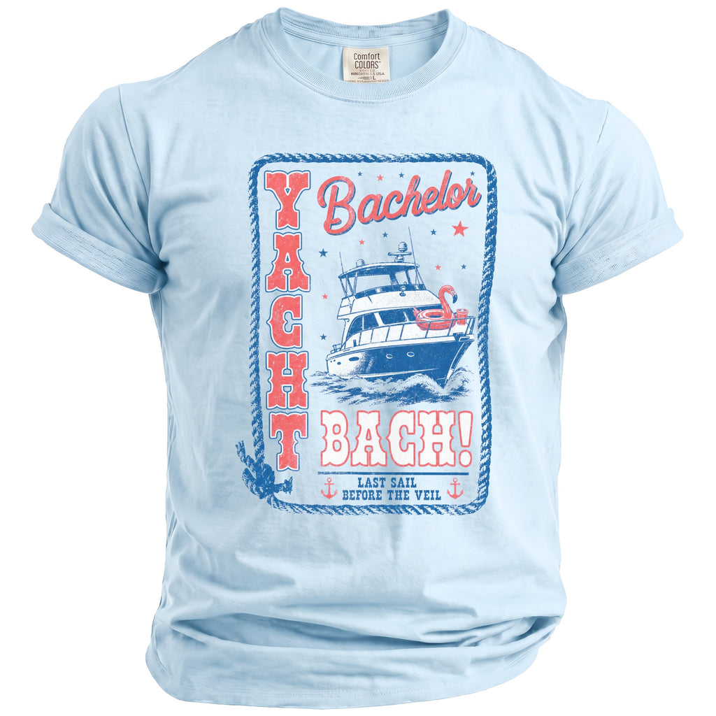 Light blue t-shirt featuring a nautical graphic with a yacht, flamingo float, and Yacht Bach text.