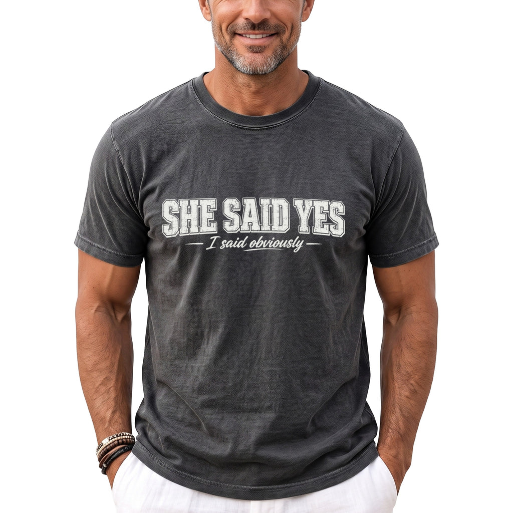 Dark gray t-shirt with white text reading "SHE SAID YES - I said obviously".