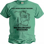 Green t-shirt with black graphic of dragon golfing with text "LAST SWING BEFORE THE RING BACHELOR GOLF WEEKEND".