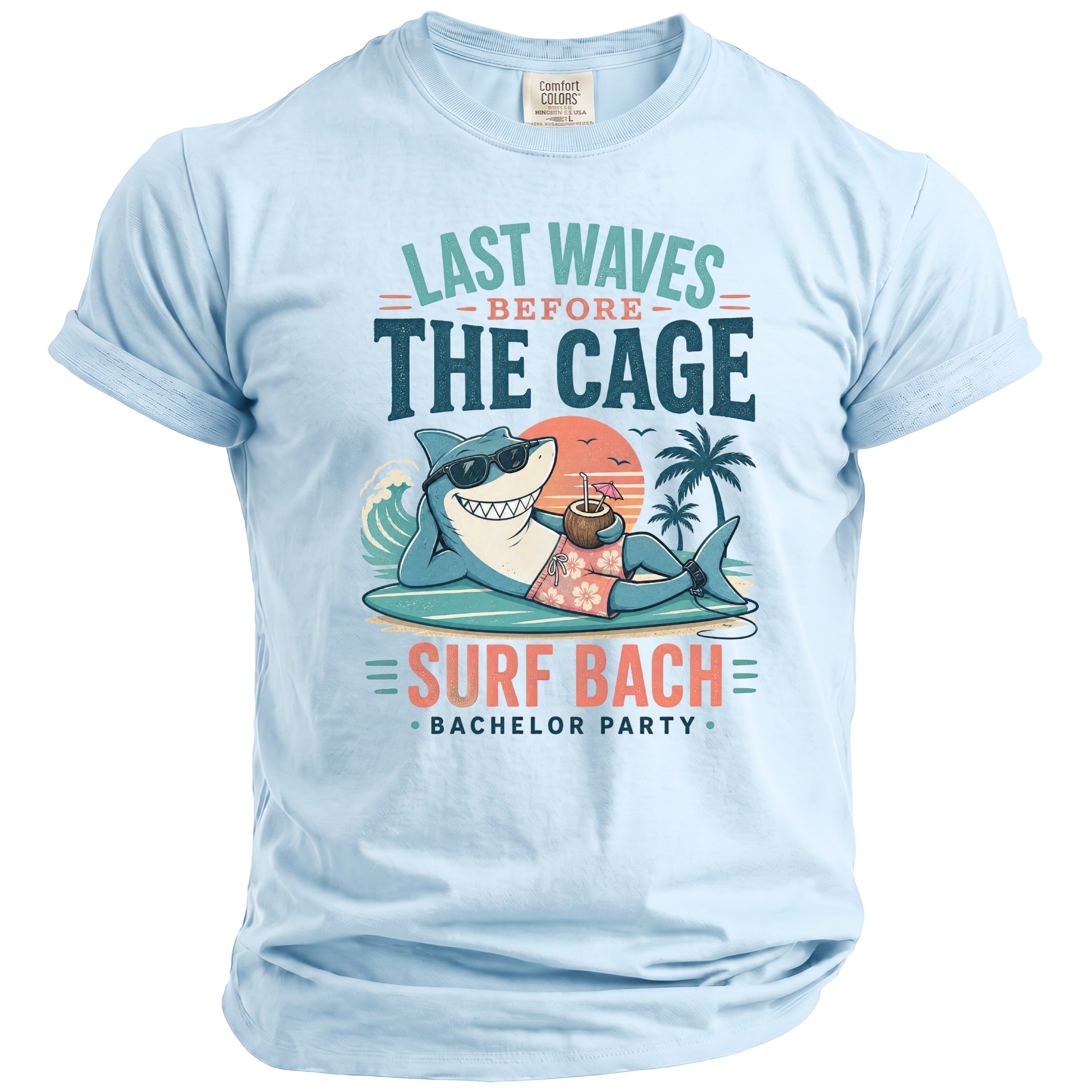 Light blue t-shirt with graphic of shark on surfboard and text "Last Waves Before The Cage Surf Bach Bachelor Party".