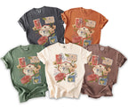 Five comfort color t-shirts in different colors with a stamp graphic.