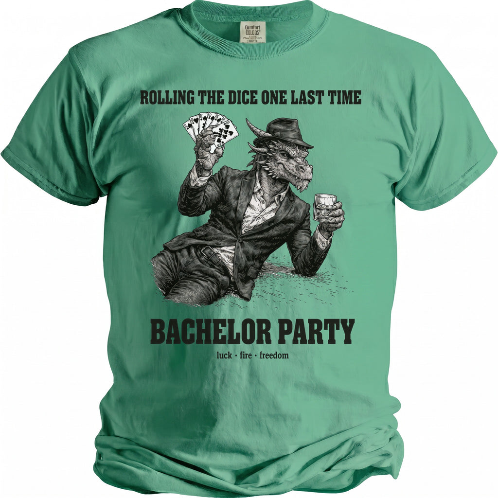 Green t-shirt with a dragon holding cards and a drink. Text: "ROLLING THE DICE ONE LAST TIME BACHELOR PARTY luck fire freedom".