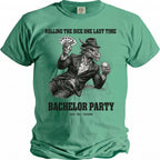Green t-shirt with a dragon holding cards and a drink. Text: "ROLLING THE DICE ONE LAST TIME BACHELOR PARTY luck fire freedom".