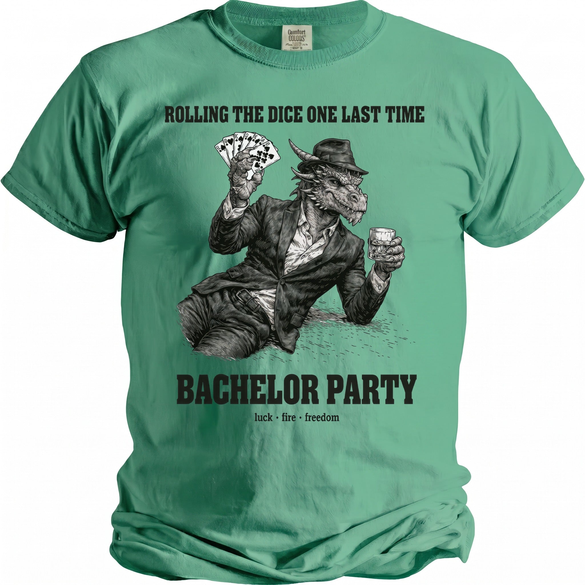 Green t-shirt with a dragon holding cards and a drink. Text: "ROLLING THE DICE ONE LAST TIME BACHELOR PARTY luck fire freedom".