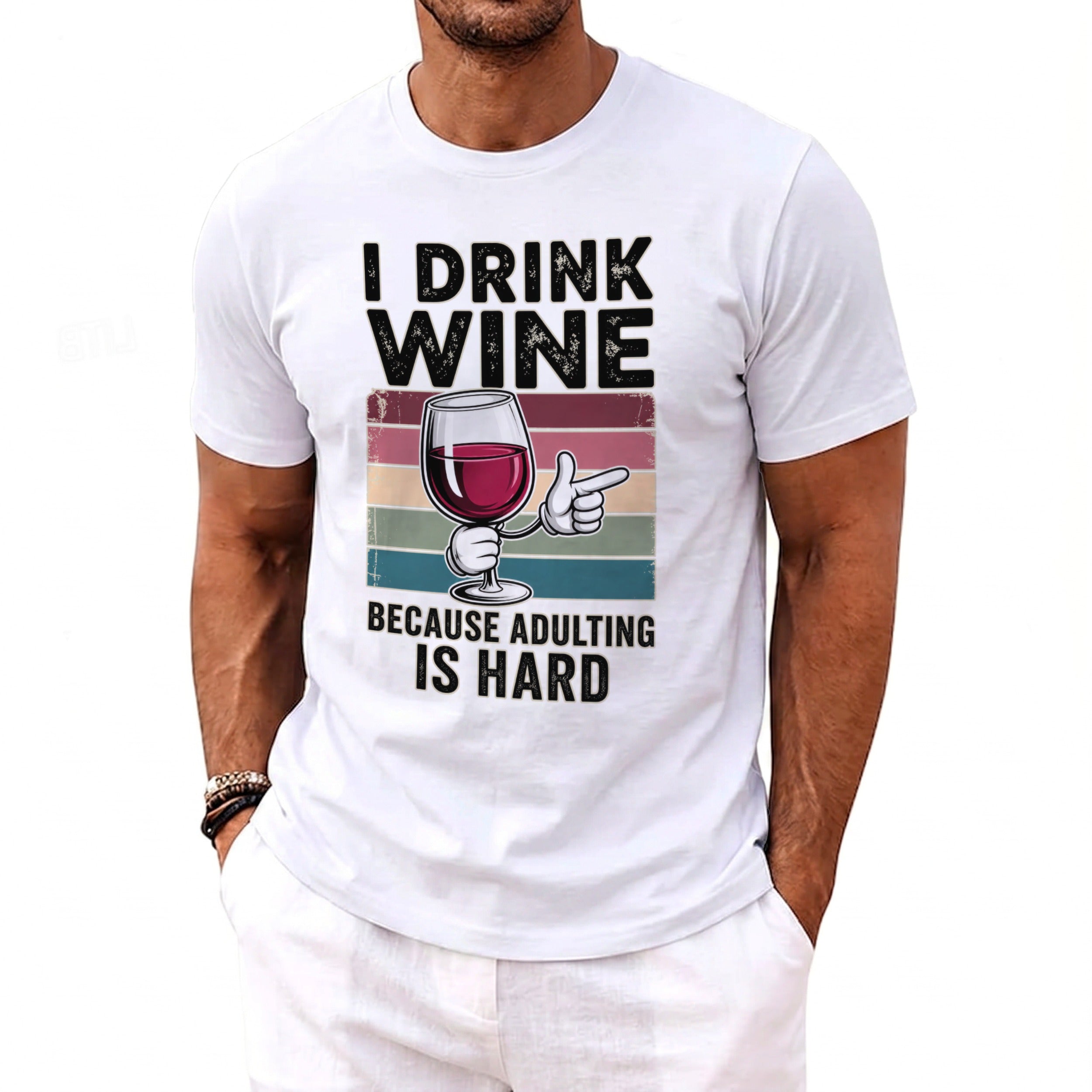 White t-shirt with black text "I DRINK WINE" above a cartoon wine glass and "BECAUSE ADULTING IS HARD".