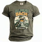 Green t-shirt with graphic of a beer mug on a mountain with text "ALPINE BACH" and "SUMMIT BEFORE THE COMMITMENT".