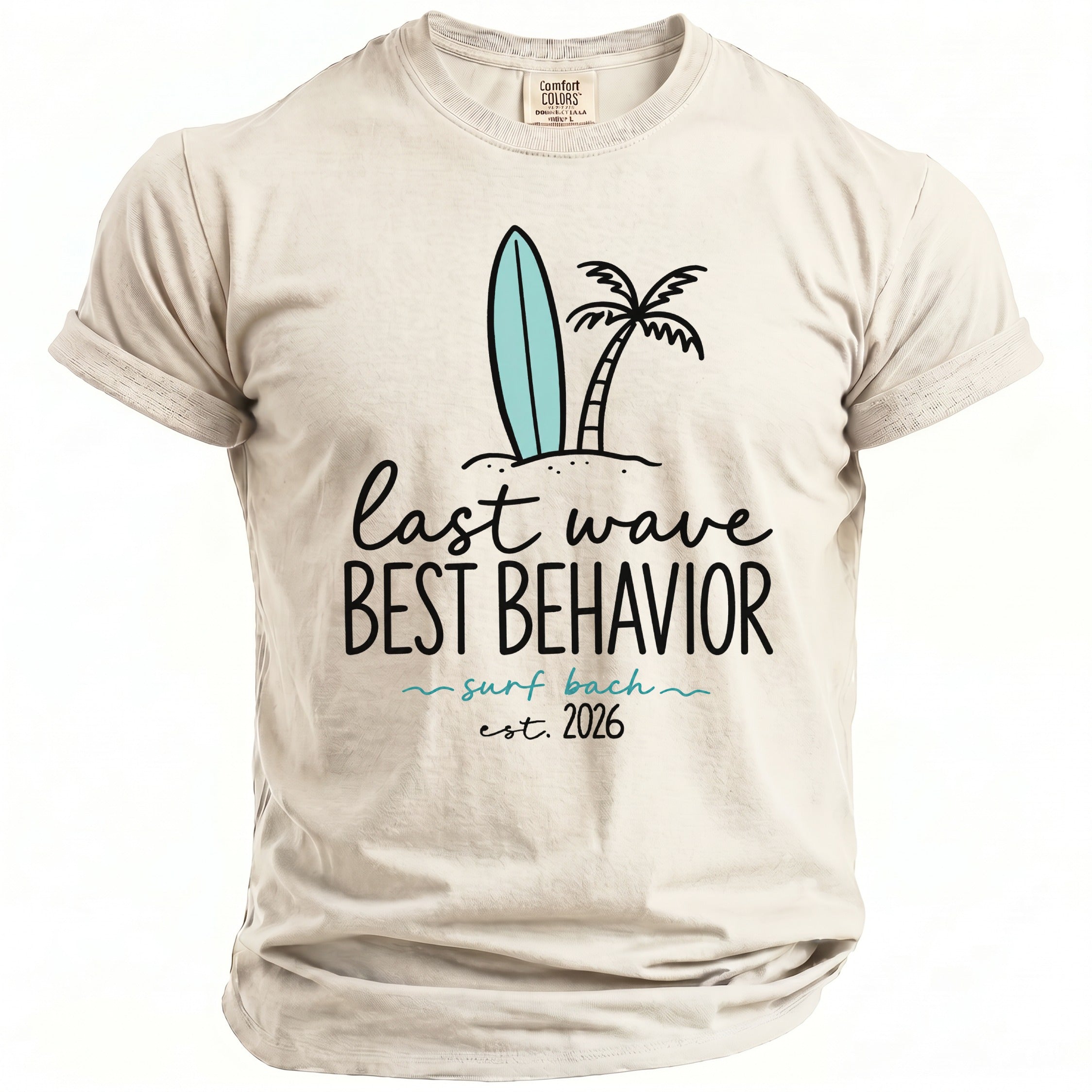 Light tan t-shirt with surfboard, palm tree, and text: "last wave BEST BEHAVIOR surf bach est. 2026".