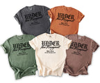 Five t-shirts in various colors with "UNDER New Management" text.