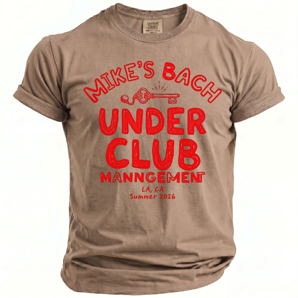 Tan t-shirt with red graphic: Mike's Bach Under Club Management, LA, CA Summer 2026.