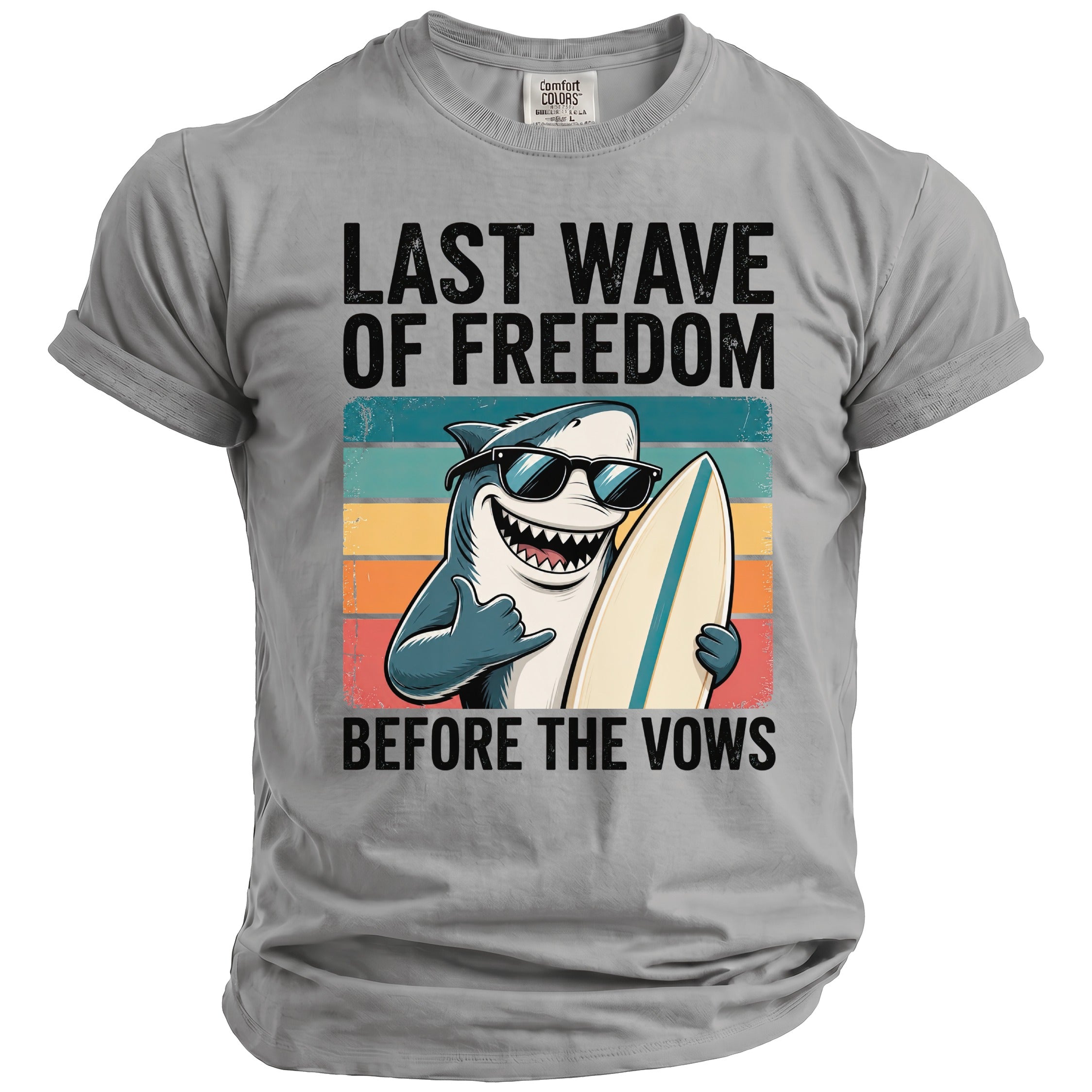 Grey t-shirt with a surfing shark graphic and text: "LAST WAVE OF FREEDOM BEFORE THE VOWS".