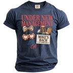 Navy t-shirt with "Under New Management" and "Mike's Bach" graphics.