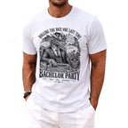 White t-shirt with graphic art of a dragon playing poker in Vegas, with "Bachelor Party" text.