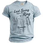 Light blue t-shirt with a graphic of a golfer, friends, golf cart, and text.