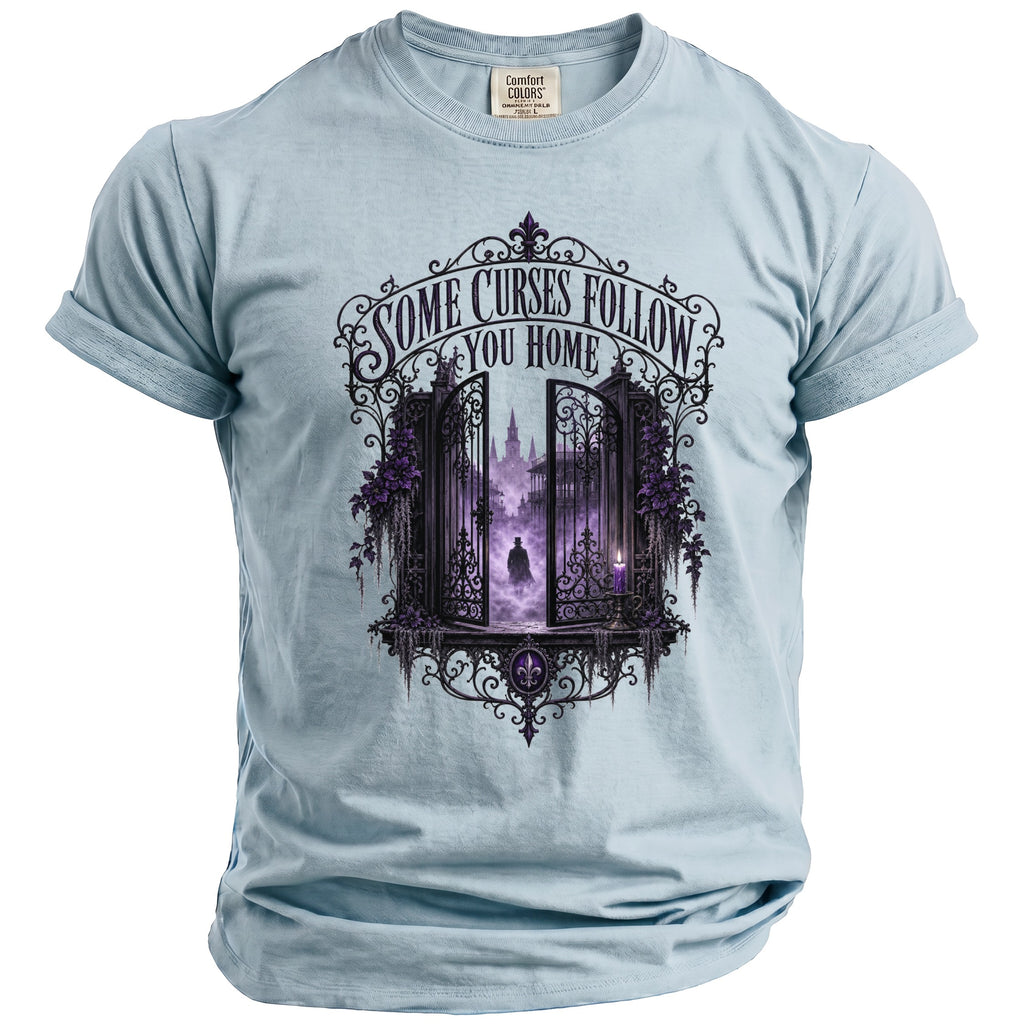 Light blue t-shirt with ornate gate graphic and text "SOME CURSES FOLLOW YOU HOME".