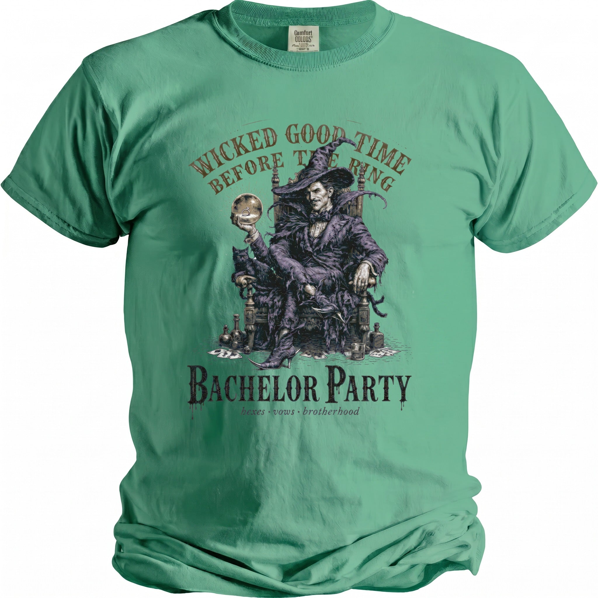 Green t-shirt with a graphic of a smiling sorcerer holding a ring and a cat, text reads "Wicked Good Time Before The Ring" and "Bachelor Party."