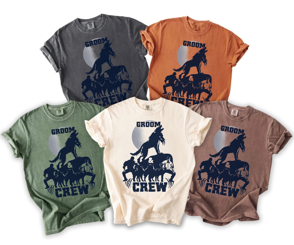 T-shirts in various colors featuring a "Groom Crew" graphic with wolves and men under a moon.