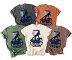 T-shirts in various colors featuring a "Groom Crew" graphic with wolves and men under a moon.