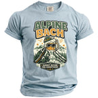 Light blue t-shirt with graphic featuring "ALPINE BACH" and "SUMMIT BEFORE THE COMMITMENT".