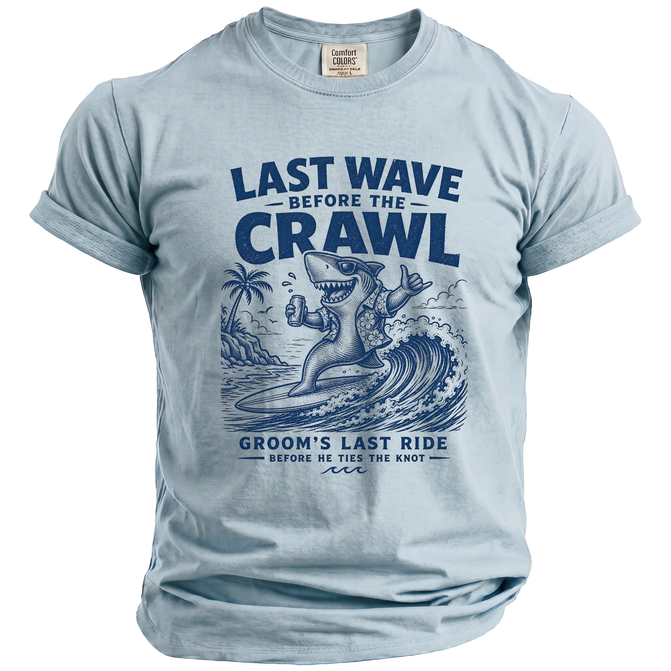 Light blue t-shirt with "Last Wave Before the Crawl" and surfer shark graphic.