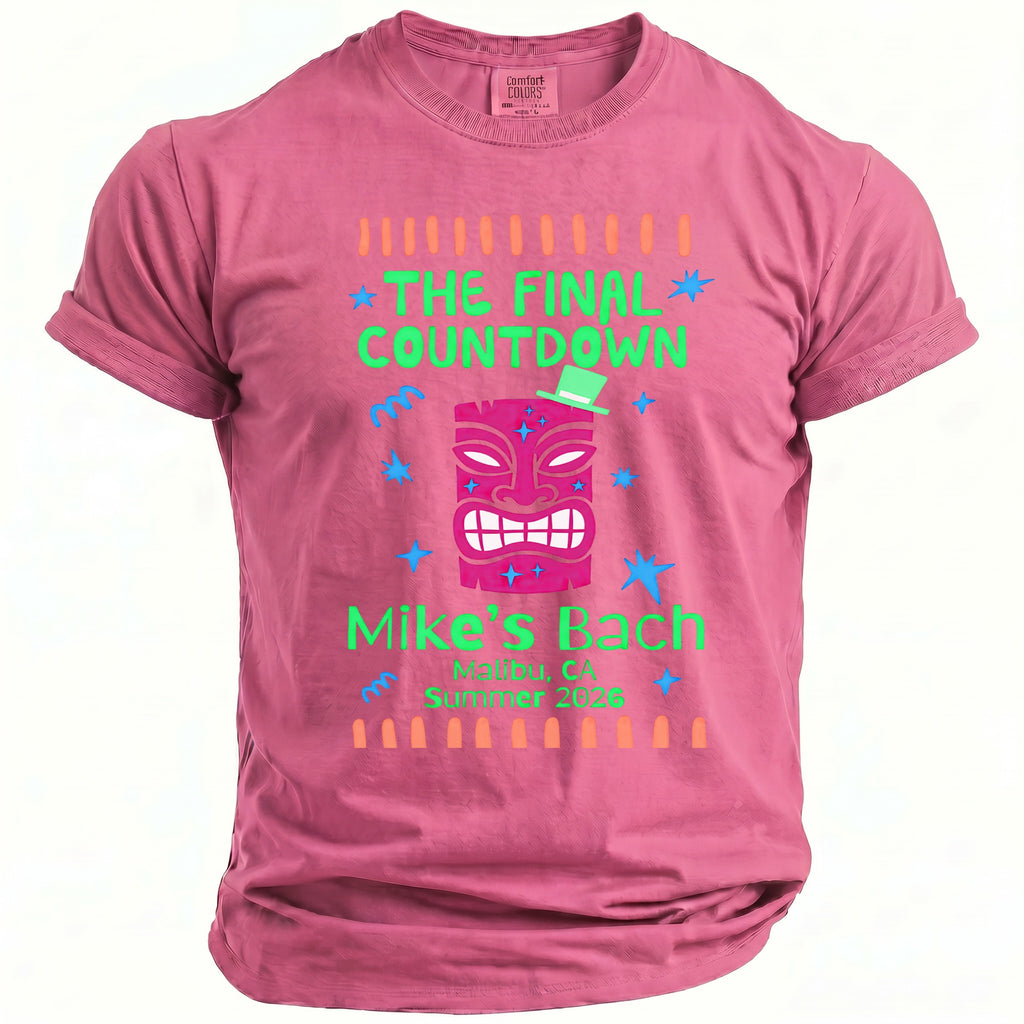 Pink t-shirt with "The Final Countdown" and "Mike's Bach" text featuring a tiki mask.
