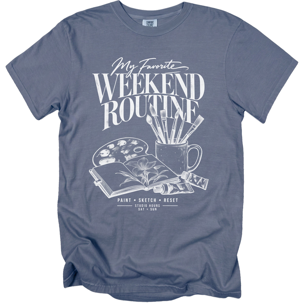 T-shirt with "My Favorite Weekend Routine" graphic featuring art supplies.