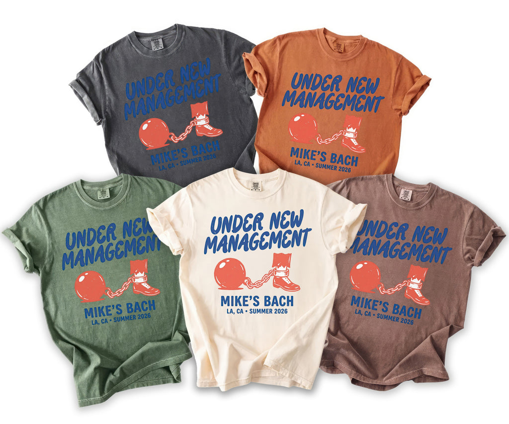 Five t-shirts in different colors display "Under New Management" and "Mike's Bach."