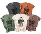 Multiple t-shirts in different colors featuring three skeletons in suits with "Spooky Crew" text.