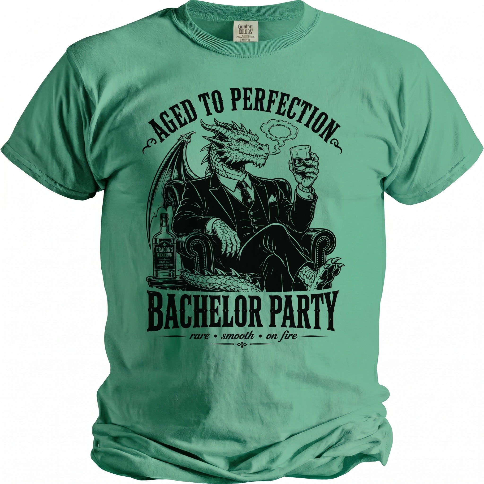 Green t-shirt with black graphics of a dragon in a suit claiming "Aged to Perfection" and "Bachelor Party".