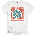 White t-shirt with retro graphic text "STAY CREATIVE" and a blue floral design.